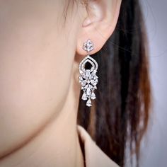 A delightfully unique pair of bridal earrings with an incredible sparkle! Lightweight, the earrings are adorned with flawlessly faceted cubic zirconia that capture the light in a dazzling array of sparkles, and are rhodium plated for a bright finish which enhances the intricate detailing and conveys a modern take on old elegance. Length: 1.25" (approx. 3.2cm). Hypoallergenic - lead, nickel and cadmium free. This exquisite design will add a touch of sophistication to any wedding gown or formal en Unique Wedding Earrings, Cubic Zirconia Bridal Earrings, Earrings Prom, Long Bridal Earrings, Silver Bridal Earrings, Bridal Statement Earrings, Lavender Earrings, Silver Crystal Earrings, Bridesmaids Earrings