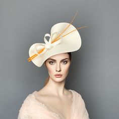 Elegant Orange and Ivory Kentucky derby hat for woman. This Orange and cream fascinate hat is embellished with a two ostrich quills and a beautiful bow. It is a perfect hat for weddings, Royal Ascot horse races, cocktails, derby... It is mounted on a headband. If you want, you can choose the side of the head were you like to wear the fascinator, just convo me. Any color of the fascinator can be changed to order. Kentucky Derby Formal Mini Hat With Bow, Elegant Kentucky Derby Hat With Bow, Elegant Bow Hat For Kentucky Derby, Formal Mini Hat With Bow For Kentucky Derby, Party Hat With Bow And Curved Brim, Fitted White Cloche Costume Hat, White Fitted Cloche Costume Hat, Elegant Cream Hat With Bow, Chic White Fitted Costume Hats And Headpieces