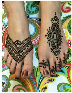 two feet with henna tattoos on them