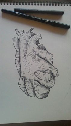 a drawing of a heart in someone's hand