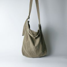 a handbag hanging on the wall in front of a white background with no one around it