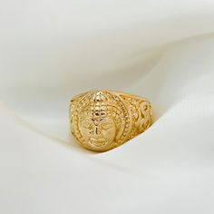 A must have for those who love meditation and spiritualism. This gold signet ring is designed with a three-dimensional, Buddha face that is certain to leave you making a statement. The chunky gold band provides extra support and durability to the piece, making it a perfect gift for those who love Buddhism and Hinduism.   ⭐️Item Details:  Ring Height: 14.5mm Band Width: 3mm Benefits: Water & Tarnish Resistant, Hypoallergenic  ⭐️Care Instructions:  1. You may shower and sleep with your gold filled Gold Adjustable Engraved Spiritual Ring, Adjustable Gold Engraved Spiritual Ring, Gold Spiritual Signet Ring For Gift, Gold Spiritual Signet Ring As A Gift, Spiritual Yellow Gold Signet Ring, Yellow Gold Open Signet Ring In Spiritual Style, Gold Buddha, Love Meditation, Buddha Face