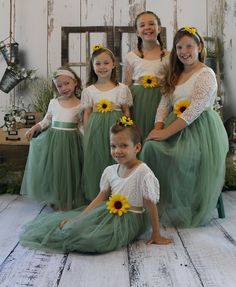 "Sage Green Tulle Flower Girl Lace Dress with Sunflower Sash & Headband For just the Sash & Headband https://www.etsy.com/listing/674949442/ This full length flower girl dress, is made with a delicate white lace bodice in Long Sleeves. The V shaped back with unfinished lace adds the perfect amount of boho chic look to this amazing dress. The long sleeves are made with just the right amount of detail. The tulle attached to top is lined to the knees with tulle extending down to mid calf or Sage Green Flower Girl Dress, Sage Green Wedding Flowers, Green Flower Girl Dress, Green Flower Girl Dresses, Burgundy Flower Girl Dress, Sage Green Flowers, Lace Long Sleeve Dress, Rustic Sunflower Wedding, Wedding Flowers Sunflowers