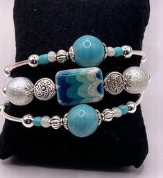 Bohemian Turquoise Cuff Bracelet With Round Beads, Adjustable Blue Stackable Wrap Bracelet, Blue Bangle With Spacer Beads, Blue Spacer Beads Bangle Jewelry, Adjustable Stackable Turquoise Cuff Bracelet, Unique Blue Beaded Bangle Bracelets, Blue Bohemian Bangle Stretch Bracelet, Turquoise Beaded Wrap Bangle Bracelet, Turquoise Multi-strand Hand Wrapped Bracelets