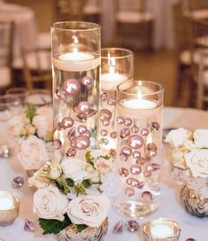 candles and flowers are sitting on a table