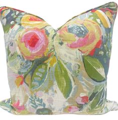 a colorful floral pillow on a white background