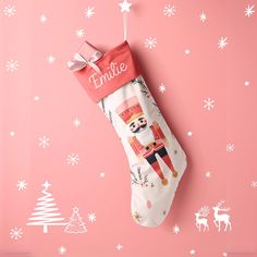 a christmas stocking hanging on a pink wall