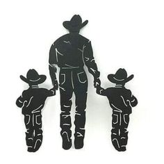 the silhouette of a man and two children wearing cowboy hats, standing next to each other