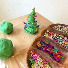 there is a wooden tray that has cookies on it and some decorations in the shape of a christmas tree