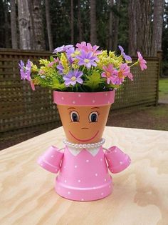 a planter with flowers in it sitting on top of a table