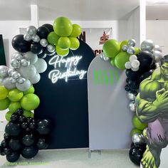 an entrance to a birthday party decorated with balloons and heliums in the shape of hulk