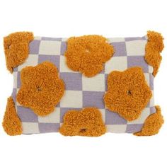 an orange teddy bear on a purple and white checkered pillow