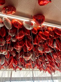 red heart shaped balloons hanging from the ceiling