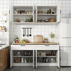 a white kitchen with open shelving above the sink and countertop, filled with utensils