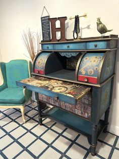 an old fashioned desk has been painted blue and gold