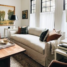 a living room filled with furniture and windows