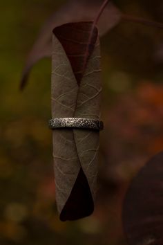 I love the design of this ring, I call it my feathery fern ring because that's what it looks like to me. The textured wraps around the entire band, and the inside of the band is rounded making it incredibly comfortable to wear. See last picture. This is a good size handcrafted sterling silver band (3.5 mm wide) with a nice weight to it. It looks great alone, or paired with other stacking rings. I've been wearing mine stacked with my triple moon ring nonstop for the last few months and it's the m Bohemian Style Engraved Ring As Gift, Bohemian Stackable Adjustable Rings For Anniversary, Bohemian Adjustable Stackable Rings For Anniversary, Bohemian Adjustable Stackable Wedding Rings, Bohemian Etched Rings For Wedding, Bohemian Engraved Promise Ring, Bohemian Etched Engraved Ring As Gift, Bohemian Engraved Open Ring For Promises, Nature-inspired Adjustable Stackable Rings For Promise