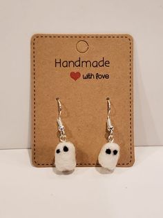 These little ghost earrings are needle felted with felting wool, and are about half an inch in size. They are super lightweight dangle earrings, and perfect for the spooky person in your life! Please do not get these wet! Made by Sarah Ostrander Spooky Gift Basket, Handmade Spooky Halloween Earrings, Needle Felt Earrings, Ghost Needle Felt, Spooky Halloween Drop Earrings, Cute Dangle Earrings, Spooky Dangle Earrings, Earrings Gothic, Jewelry Halloween