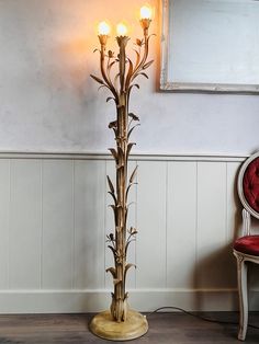 a lamp that is sitting on top of a table next to a chair and mirror