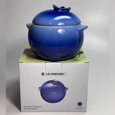 a blue pot sitting on top of a box