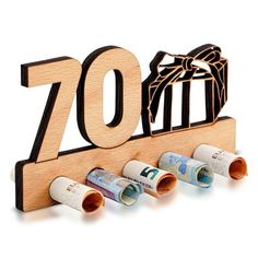 a wooden sign that says 70th with rolled up money