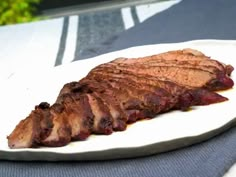 a piece of meat sitting on top of a white plate