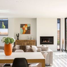 a living room filled with furniture and a fire place next to a sliding glass door