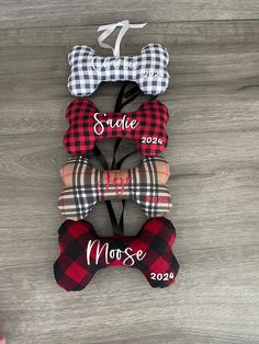 three personalized dog bone tags in plaid and gingham fabric, one with a name on it