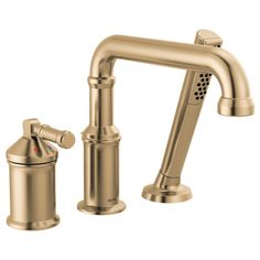 a faucet with two handles and nozzles on the side, in gold