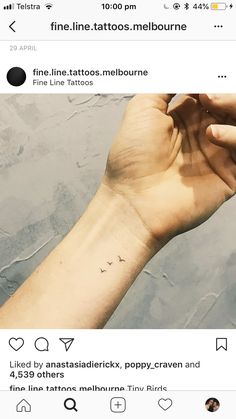 a person's arm with a small tattoo on it