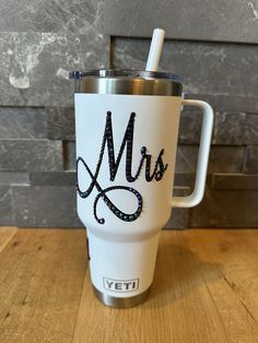 a white yeti cup with the word mrs on it