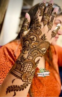 a woman's hand with henna on it