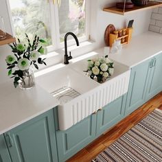 a kitchen with two sinks and green cabinets