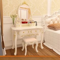 a white dressing table with a mirror and stool next to it on a wooden floor