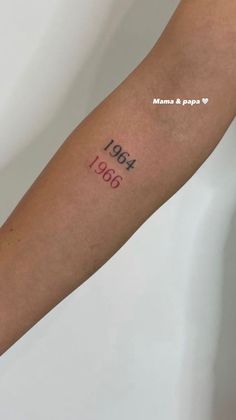 a woman's arm with a tattoo that reads 1960 on the left side of her arm