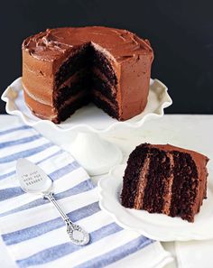 a chocolate cake with one slice cut from it