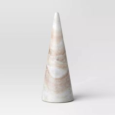 a marble cone shaped object on a white background