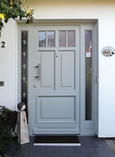 a grey front door with glass panels