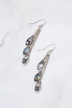 Discover the beauty and versatility of the Reflections Collection! Every piece is meticulously handcrafted with carefully selected materials. These tassel earrings perfectly complement the collection, adding an elegant touch to your style. Elevate your look with Reflections! Antique Silver Plated Brass (Lead & Nickel Free) Crystal 2.5" with sterling silver ear wires We hand select our natural materials, thus there may be slight variations in color and/or size that will not detract from the overa Elegant Silver Earrings With Tassels, Elegant Silver Nickel-free Tassel Earrings, Elegant Beaded Dangle Earrings With Tassels, Elegant Silver Tassel Earrings Nickel Free, Elegant Silver Tassel Earrings With Dangling Beads, Silver Dangle Earrings With Tassels, Silver Long Drop Earrings With Tassels, Elegant Beaded Earrings With Tassels For Gift, Elegant Gift Beaded Earrings With Tassels