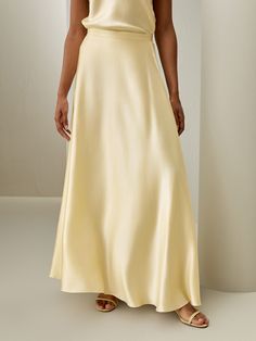 Show off your feminine side with this flowing umbrella shaped maxi skirt. The fabric's inherent sheen and smooth texture add an element of opulence to the overall design, while the inner silk chiffon adds a layer of solidity. Crafted from the finest material, it can be paired with multiple styles for a variety of events. Luxury Satin Wide Leg Maxi Skirt, Luxury Elegant Cream Maxi Skirt, Luxury Bias Cut Party Maxi Skirt, Luxury Relaxed Maxi Skirt For Evening, Chic Luxury Bias Cut Maxi Skirt, Luxury Gold Skirt For Wedding, Luxury Wide Leg Lined Maxi Skirt, Luxury Relaxed Fit Evening Maxi Skirt, Luxury Flowy Silk Maxi Skirt