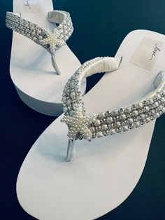 Absolutely Stunning Beaded Rhinestone /Pearl Trim Line these Straps with a Starfish Pearl Rhinestone Button Added for a touch of extra Bling for a Spectacular Wedding Experience! An Inner Layer of Satin underneath added for comfort. Rush Orders Offered https://www.etsy.com/listing/211630967/rush-order?ref=shop_home_active_7&frs=1 Ships Worldwide  Contact Shop Owner 7 Days a Week for Speedy Replies ! Summer Pearl White Wedding Shoes, White Pearl Wedding Shoes For Summer, Bridesmaid Flip Flops, Bridal Flip Flops, Wedding Shoes Sandals, Wedding Flip Flops, Beach Wedding Shoes, Comfortable Flip Flops, Wedding Shoes Lace