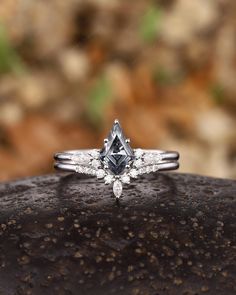 a diamond ring sitting on top of a rock