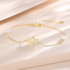 💕 STYLISH DESIGN 💕 Lotus flower means purity and nobility, it brings us peace and healing power. The 14k real gold lotus pearl bracelet designed by FANCIME is a symbol of pure love and friendship. Adjustable design 6.7”+0.59''+0.59” extend chain, adjusts to fit most wrists. 💕 FINE JEWELRY 💕 The FANCIME Solid 14k Gold Bracelet is well crafted in 14k gold with Au585 stamp. (In real 14 carat gold, not just covering). Two freshwater cultured pearls make this bracelet more elegant and luxury. All Lotus Flower Bracelet, Elegant Gold Bracelet Simple, Gold Lotus Flower, Real Gold Bracelet, Real Pearl Jewellery, Lotus Bracelet, Gold Bracelet Simple, Lotus Jewelry, Gold Lotus