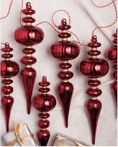 red glass christmas ornaments with gold ribbons and bows