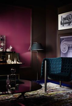 a living room with purple walls and furniture