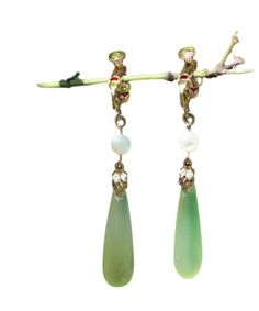 Indulge in luxury with our Chic Green Sterling Silver Alloy Pearl Drop Earrings. The alluring green stones sit delicately on the sterling silver alloy, reflecting sophistication and elegance. The perfect accessory for any occasion, these earrings will elevate your style and leave a lasting impression. Measurement: 5cm/1.95" * 0.9cm/0.351". Matches easily with daily hairstyle. dresses & Shirts Green Fine Jewelry Drop Earrings, Fine Jewelry Green Drop Earrings, Green Pierced Earrings For Formal Occasions, Green Teardrop Clip-on Earrings, Formal Green Pierced Earrings, Elegant Green Jade Jewelry, Elegant Jade Dangle Earrings, Teardrop Jade Earrings For Formal Occasions, Elegant Single Jade Earring