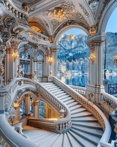 an ornate staircase in the middle of a building with snow on the ground and mountains in the background