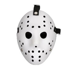 a white mask with black dots on it