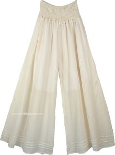 A pair of palazzo pants in ivory off white that you can wear in every season, these pants are extremely comfortable and are made of lightweight cotton fabric. The bottom of the pants is very wide, which gives it a flow and a feminine look as you walk. These pants have pin tuck details at the bottom near the hemline. Perfect for summer evenings out with friends, you can simply wear these casual wide-leg pants with a solid top of any color you like according to the occasion. Wear some jewelry to e Cream Cotton Wide Leg Pants For Spring, Cream Bohemian Pants For Spring, White Wide-leg Harem Pants With Elastic Waistband, White Wide Leg Harem Pants For Loungewear, Bohemian White Wide Leg Pants With Elastic Waistband, White Bohemian Wide Leg Pants With Elastic Waistband, White Harem Pants With Loosely Fitted Hips, White Bohemian Cotton Harem Pants, White Flowy Chic Bottoms