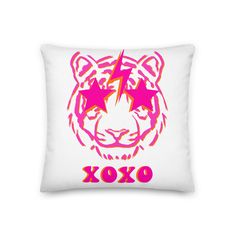 a white pillow with a pink and red tiger head on the front that says xoxo